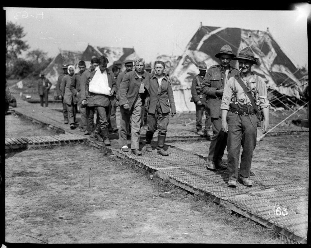 Led by New Zealanders, young and wounded German soldiers arrive at a New Zealand field hospital.